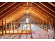 Expansive unfinished attic space with exposed wooden beams, offering potential for storage or conversion at 104 Buckden Pl, Cary, NC 27518