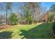 Lush, green backyard with mature trees providing shade and privacy at 104 Buckden Pl, Cary, NC 27518