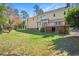 Spacious backyard with lush green grass and a view of the house featuring a deck at 104 Buckden Pl, Cary, NC 27518