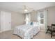 Light-filled bedroom boasts a ceiling fan and windows at 104 Buckden Pl, Cary, NC 27518