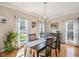 Bright dining room featuring hardwood floors, chandelier, and beautiful natural light at 104 Buckden Pl, Cary, NC 27518