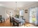 Dining room features a chandelier, hardwood floors, and many windows at 104 Buckden Pl, Cary, NC 27518