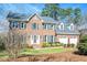 Charming brick home with manicured lawn, two-car garage and inviting entryway at 104 Buckden Pl, Cary, NC 27518