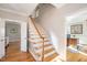 Inviting foyer showcasing hardwood floors and an elegant staircase leading to upper level at 104 Buckden Pl, Cary, NC 27518
