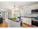 Spacious kitchen with central island, granite counters, and open layout at 104 Buckden Pl, Cary, NC 27518
