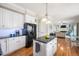 Kitchen with granite countertops, white cabinets, and stainless steel appliances at 104 Buckden Pl, Cary, NC 27518