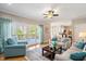Bright living room with hardwood floors, deck access, and comfortable seating at 104 Buckden Pl, Cary, NC 27518