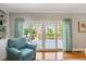 Bright living room seating area with hardwood floors and deck access at 104 Buckden Pl, Cary, NC 27518