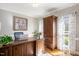 Office area with large desk, statement art and natural light at 104 Buckden Pl, Cary, NC 27518