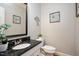 Updated powder room featuring granite countertops, modern fixtures, and elegant decor at 104 Buckden Pl, Cary, NC 27518
