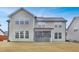 Exterior view of the home showcasing the backyard, siding, multiple windows, and screened in porch at 104 Red Bark Ct, Apex, NC 27539
