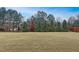 View of the home's backyard featuring a large lawn and a variety of trees at 104 Red Bark Ct, Apex, NC 27539