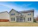 Exterior view of the home showcasing the backyard, siding, screened porch, and various windows at 104 Red Bark Ct, Apex, NC 27539