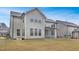 Exterior view of the home with a vast backyard, screened porch, and multi-paned windows at 104 Red Bark Ct, Apex, NC 27539