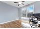 Bedroom with light blue walls, natural light, and a desk set up next to the window at 104 Red Bark Ct, Apex, NC 27539