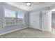 Comfortable bedroom features a closet and natural light from a large window at 104 Red Bark Ct, Apex, NC 27539