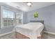 Charming bedroom features a bed, ceiling fan and natural light from a window at 104 Red Bark Ct, Apex, NC 27539