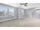 Spacious carpeted bonus room with ceiling fan and windows for natural light at 104 Red Bark Ct, Apex, NC 27539