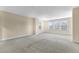 Large bonus room with light yellow walls, carpet, and two windows for natural light at 104 Red Bark Ct, Apex, NC 27539