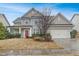 Charming two-story home featuring a well-manicured lawn and an attached two-car garage at 104 Red Bark Ct, Apex, NC 27539