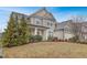 Inviting two-story home with a manicured lawn, attractive landscaping, and a welcoming front porch at 104 Red Bark Ct, Apex, NC 27539