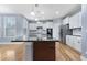 Contemporary kitchen with granite countertops, stainless steel appliances, and a central island at 104 Red Bark Ct, Apex, NC 27539