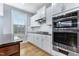 Updated kitchen with stainless steel appliances, gas cooktop, white cabinets, and granite countertops at 104 Red Bark Ct, Apex, NC 27539