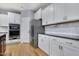 Bright kitchen with stainless steel appliances, white cabinetry, subway tile backsplash and hardwood flooring at 104 Red Bark Ct, Apex, NC 27539
