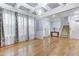 Elegant living room featuring hardwood floors, coffered ceiling, and ample natural light at 104 Red Bark Ct, Apex, NC 27539
