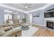 Cozy living room with hardwood floors, a fireplace, and comfortable seating area at 104 Red Bark Ct, Apex, NC 27539