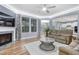 Inviting living room with a fireplace, hardwood floors, and plenty of natural light at 104 Red Bark Ct, Apex, NC 27539