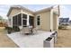 Charming backyard patio with an umbrella table, surrounded by a manicured lawn at 104 Sage Oak Ln, Holly Springs, NC 27540