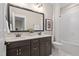 Bright bathroom featuring double sink vanity with modern finishes and a shower-tub combo at 104 Sage Oak Ln, Holly Springs, NC 27540