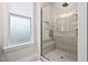 Modern bathroom featuring glass-enclosed shower with gray tile and a built-in seat at 104 Sage Oak Ln, Holly Springs, NC 27540