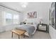 Stylish bedroom with panelled accent wall, matching night stands, and ample natural light at 104 Sage Oak Ln, Holly Springs, NC 27540