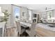 Bright dining room with large windows, elegant curtains, and an adjacent living room with fireplace at 104 Sage Oak Ln, Holly Springs, NC 27540