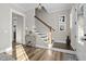Inviting foyer with hardwood floors, staircase, and elegant decor at 104 Sage Oak Ln, Holly Springs, NC 27540
