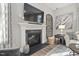 Elegant fireplace with mantel, decorative accessories, and a large television above at 104 Sage Oak Ln, Holly Springs, NC 27540