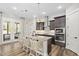 Modern kitchen with granite countertops, stainless steel appliances, and a stylish island with seating at 104 Sage Oak Ln, Holly Springs, NC 27540