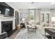 Cozy living room with a fireplace, stylish decor, and comfortable seating at 104 Sage Oak Ln, Holly Springs, NC 27540