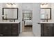 Double vanity main bath with dark wood cabinets, granite countertops, and view to main bedroom at 104 Sage Oak Ln, Holly Springs, NC 27540