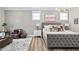 Spacious main bedroom features neutral walls, paneled accents, hardwood floors, and ample seating at 104 Sage Oak Ln, Holly Springs, NC 27540