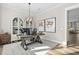 Stylish home office featuring a modern desk, elegant decor, and hardwood floors at 104 Sage Oak Ln, Holly Springs, NC 27540