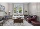 Comfortable sitting room with a large window, paneled walls, hardwood floors, and comfortable seating at 104 Sage Oak Ln, Holly Springs, NC 27540