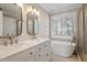 Spa-like bathroom with double vanity, soaking tub, and modern fixtures at 104 Somerset Farm Dr, Holly Springs, NC 27540