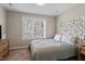 Primary bedroom featuring a decorative headboard, natural lighting, and neutral decor at 104 Somerset Farm Dr, Holly Springs, NC 27540