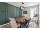 Dining room with modern lighting and a patterned accent wall for a stylish look at 104 Somerset Farm Dr, Holly Springs, NC 27540