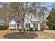 Charming two-story home with a landscaped front yard and inviting curb appeal at 104 Somerset Farm Dr, Holly Springs, NC 27540