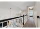 Second floor hallway featuring carpet, natural lighting, and decorative hanging lights at 104 Somerset Farm Dr, Holly Springs, NC 27540