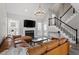 Spacious living room with fireplace, high ceilings, and a staircase at 104 Somerset Farm Dr, Holly Springs, NC 27540